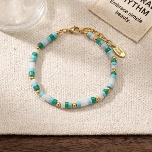 Summer beach style beaded bracelet with colorful disc beads, gold metal accents and cute tag.