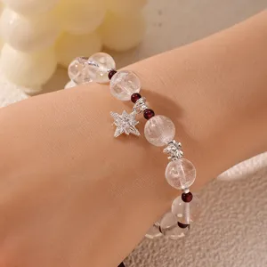 Detail view of a Chinese style crystal beaded bracelet with a star charm for women.