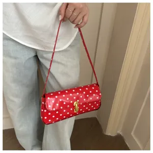 Red polka dot shoulder bag for women, stylish patent leather baguette purse for daily work.