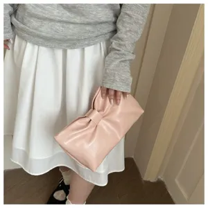Détail de pochette nuage plissée nœud rose chic, design de sac à main de soirée élégant, mode.