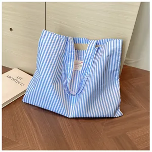 Blau-weiße Canvas-Tasche mit Streifen, große Freizeittasche für den täglichen Weg zur Arbeit.