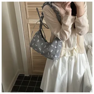 Detailed shot of Korean style black and white checkered canvas shoulder bag with bow.