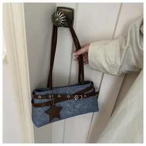 Minimalist casual grey shoulder bag for women, stylish handbag with brown straps and star pendant.
