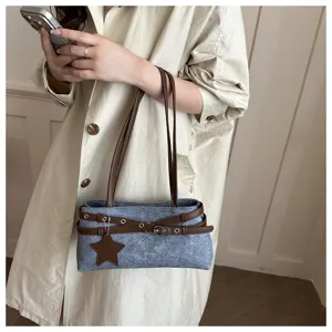 Detailed view of casual grey shoulder bag with brown double belts and star charm.