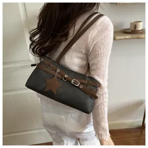 Detail view of stylish minimalist casual shoulder bag featuring cute star pendant and brown straps.