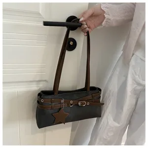 Minimalist dark grey shoulder bag with brown straps, stylish buckle and star charm detail.