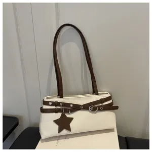 Stylish white shoulder bag with brown straps, double belt design and star charm accessory.