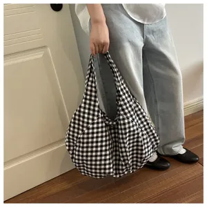 Detailed shot of a black and white gingham tote bag showcasing the soft fabric and daily casual style.