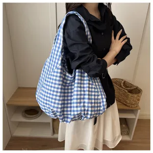Detail view of Korean vintage blue white plaid tote bag, showing large capacity on model.