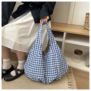 Blue and white plaid fabric shoulder bag detail shot, casual lightweight tote bag scene display.