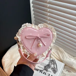 Korean style pink heart-shaped children shoulder bag with cute polka dots and bow lace trim.