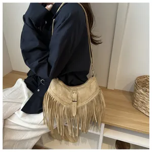 Bohemian suede fringe shoulder bag for women, vintage brown crossbody purse with metal buckle.