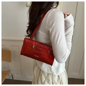 Red patent leather shoulder bag detail, stylish underarm bag for casual daily use.