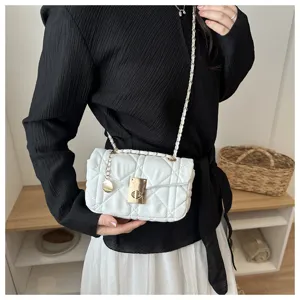 White quilted chain crossbody bag detail shot, featuring stylish turn-lock and elegant design.