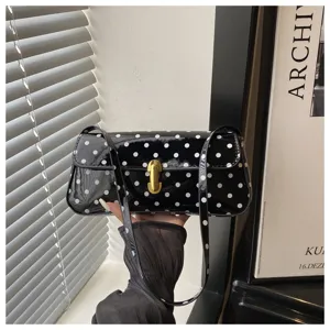 Black patent leather polka dot shoulder baguette bag, stylish retro commuting handbag for women.