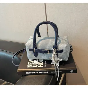 Chic denim pillow shoulder bag with stylish belt buckle and star charm for women, new spring style.