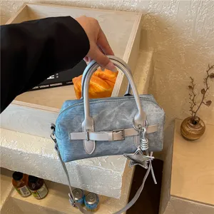 Chic denim pillow shoulder bag with trendy buckle design, versatile crossbody handbag for women.