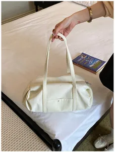 Detail view of a Korean style large capacity white casual shoulder bag with dual handles.