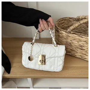 White quilted chain shoulder bag with metal lock clasp, elegant crossbody square purse.