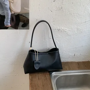 Chic minimalist black underarm shoulder bag for women, stylish daily commuter handbag.