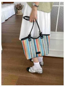 Detailed view of the stylish colorful striped straw tote bag, perfect for summer vacation.