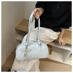 Chic light blue shoulder pillow bag for women, trendy fashion handbag with pearl bow detail.