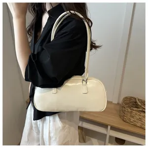Chic white underarm shoulder bag detail, stylish pillow handbag design for women.