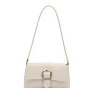Minimalist white patent leather underarm shoulder bag with gold buckle for women commuter.