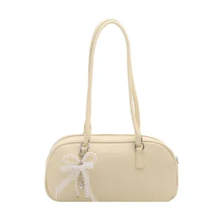 Elegant cream shoulder pillow bag for women, versatile PU leather tote with chic pearl bow charm.