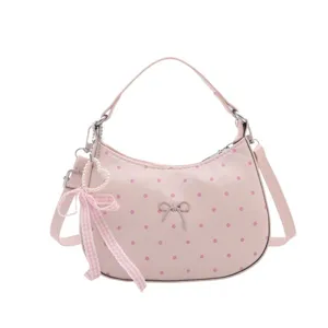 Pink polka dot dumpling bag with bow and pearl pendant, stylish casual crossbody handbag.