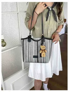 Stylish color-block woven tote bag with cute bear pendant, perfect for daily commute and casual travel.