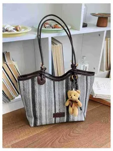 Large capacity commuter striped straw woven tote bag featuring leather handles and cute bear charm.