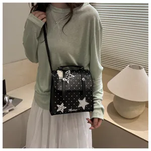 Stylish black polka dot backpack with star patches, casual school style shoulder bag.