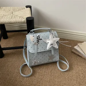 Light blue polka dot backpack with star patches and cute star pendant for women style daily.