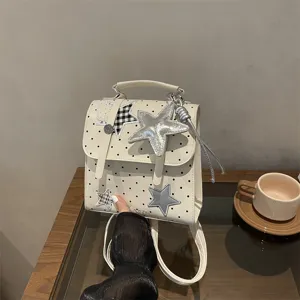White polka dot backpack for women, cute star pendant school bag casual daily daypack chic.