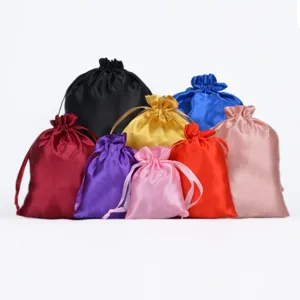 A collection of colorful silk satin drawstring gift pouches on a white background