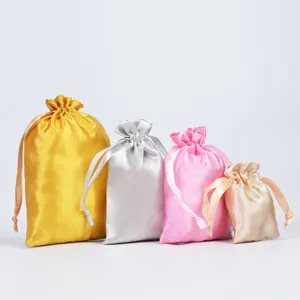 Variety of satin drawstring pouches in gold, silver, pink, and champagne colors