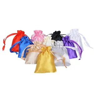 Detailed view of multiple colorful satin drawstring gift pouches in various vibrant shades