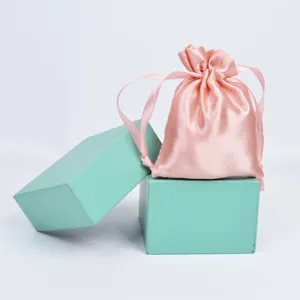 Close-up of pink satin drawstring pouch with elegant silk-like ribbon closure