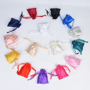 Assorted colorful satin drawstring gift pouches in a circular layout on white background