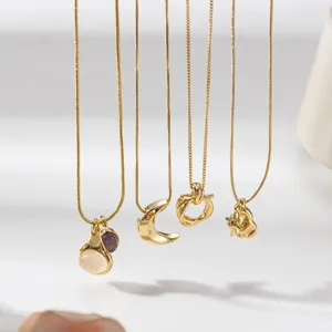 Set of four elegant gold pendant necklaces featuring moon, natural stone, and knot charms.