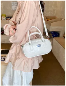 Stylish white bowling bag, versatile Boston shoulder handbag for women. Premium daily purse.