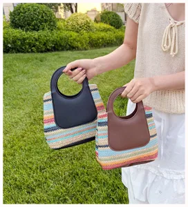 Detail view of the colorful striped straw handbag with round leather handle for summer daily wear.