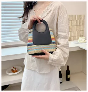 Detail view of colorful striped straw handbag with black handle for chic summer daily use.