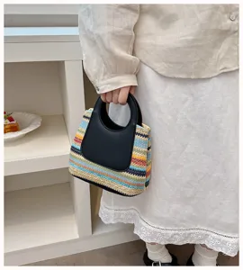 Detailed view of the colorful rainbow woven straw handbag with black round handle for summer daily use.