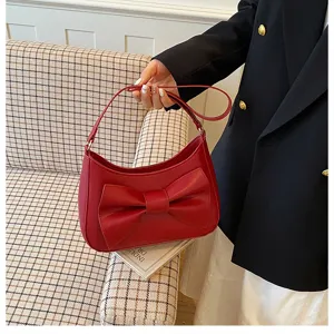 Chic red underarm shoulder bag for women with bow design, perfect for daily casual commuting.