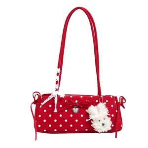 Red polka dot shoulder bag for women with cute fluffy bunny plush pendant and bow charm.