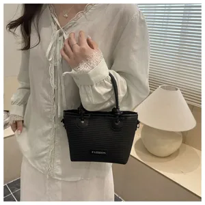 Black woven bucket handbag detail, chic knot handle and elegant design for daily wear.