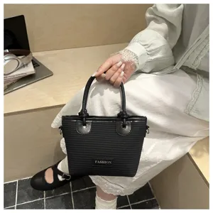 Black woven bucket handbag with knot handle, stylish straw tote bag for beach and daily.