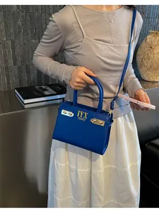Chic royal blue shoulder bag with metal hardware and stylish design for modern women daily use.